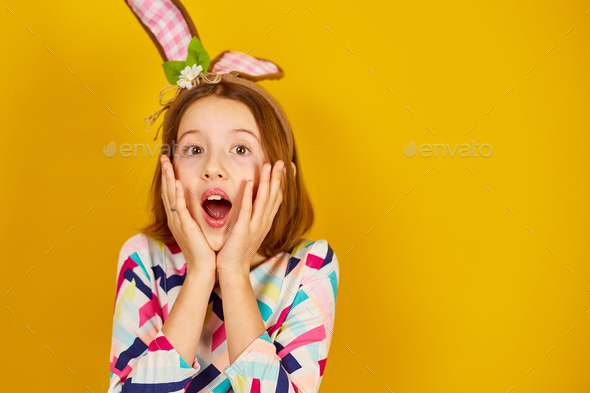 Happy playful teenager girl wearing bunny ears - Stock Photo - Images