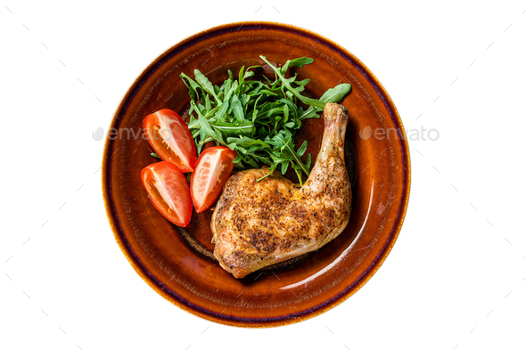 Poultry dish - roasted chicken legs with vegatables salad. Isolated on white background