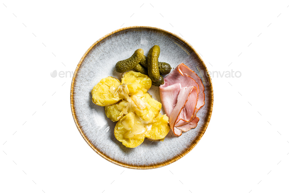Melted Raclette Swiss cheese with boiled potato and ham. Isolated on white background