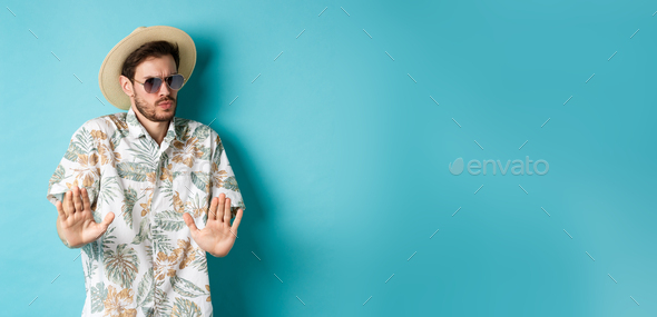 Alarmed tourist asking to stay away, step back from something cringe, showing rejection gesture