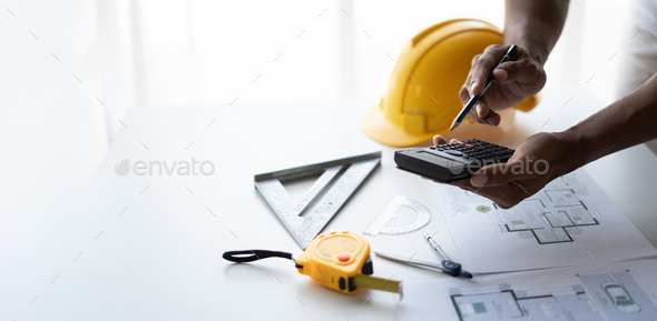 Engineer drawing a blue print design building or house, An engineer ...