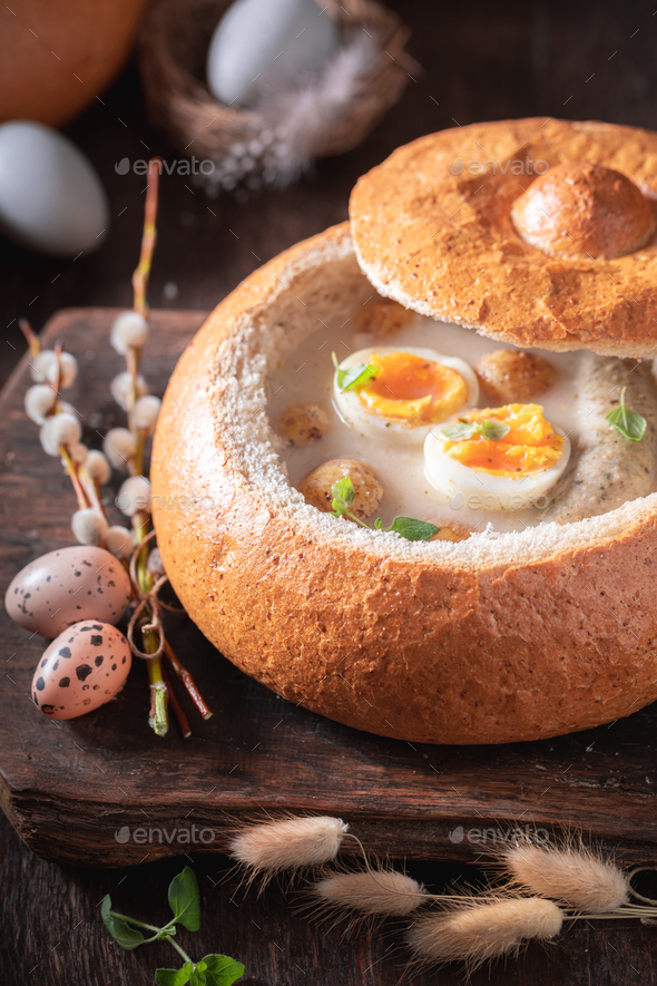 Classic sour soup with marjoram, egg and white sausage. Stock Photo by
