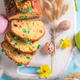 Delicious Fruitcake for Easter surrounded by eggs and spring flowers. - PhotoDune Item for Sale