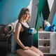 Pregnant woman with big belly in black bodysuit. Girl photoshoot in children&#39;s room playing with  - PhotoDune Item for Sale