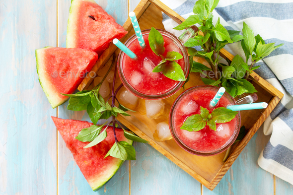 Watermelon drink in glasses and slices of watermelon on rustic wooden table.   - Stock Photo - Images