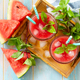 Watermelon drink in glasses and slices of watermelon on rustic wooden table.   - PhotoDune Item for Sale