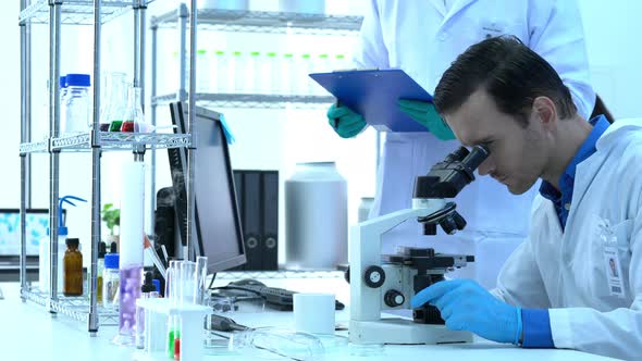 Scientist looking microscope