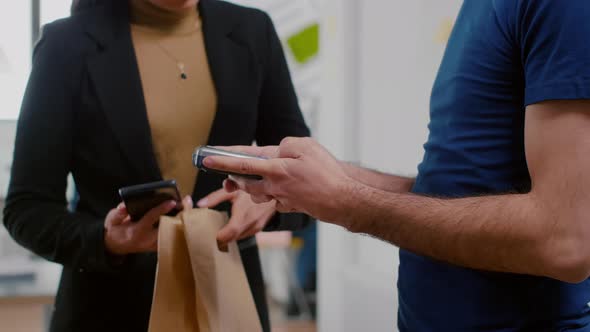Closeup of Delivery Man Holding Takeaway Food Order Meal Bringing at Company Office alt