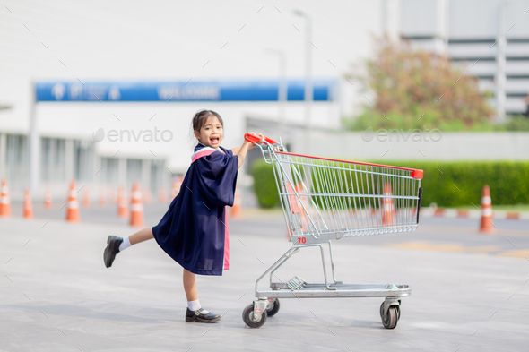 Happy Asian girls in graduation gowns on their graduation day at school.Graduation concept  - Stock Photo - Images