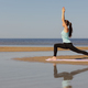 yoga, Warrior Pose, sporty woman does warm-up on seashore in morning. - PhotoDune Item for Sale