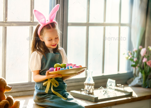 child with Easter painting eggs - Stock Photo - Images