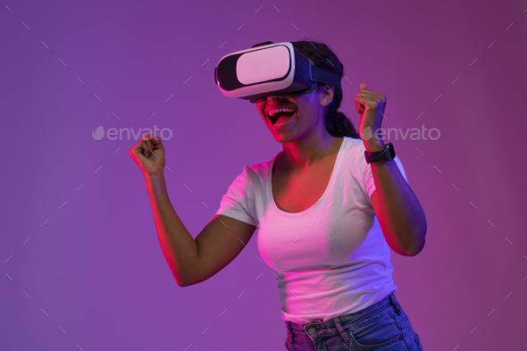 Happy Excited Black Lady Wearing VR Headset Celebrating Win In Video Game