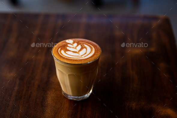 Glass of flat white coffee with heart shaped foam milk - Stock Photo - Images