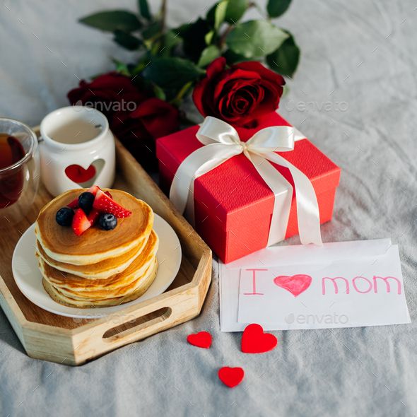 Mother's Morning breakfast on wooden tray with greeting card I love you mom - Stock Photo - Images