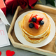 Banner image for desing web page. Mother&#39;s Day concept. Pancakes with berry, tea cup, burning candle - PhotoDune Item for Sale