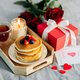 Holiday breakfast or brunch set served on gray bed with flowers, gift box and candle. - PhotoDune Item for Sale