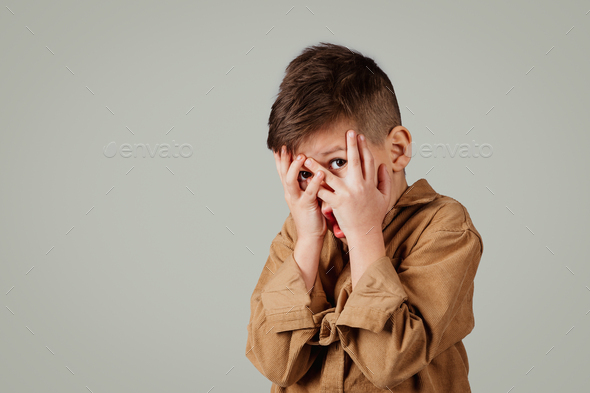 Scared Young Boy with Hands on His Face Stock Photo - Image of