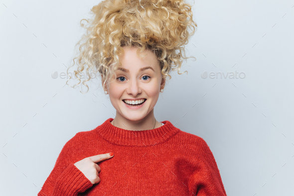 Happy funny beautiful young woman with pleased expression, rejoices her new purchase - Stock Photo - Images