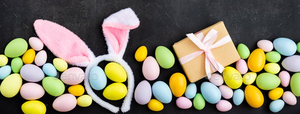 Stylish background with colorful easter eggs on dark concrete background - Stock Photo - Images