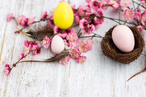 Stylish background with colorful easter eggs on white wooden background with copy space - Stock Photo - Images