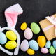 Stylish background with colorful easter eggs on dark concrete background - PhotoDune Item for Sale