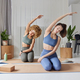 Sporty women practice yoga pose on fitness mat dressed in sportswear leans aside have pilates - PhotoDune Item for Sale