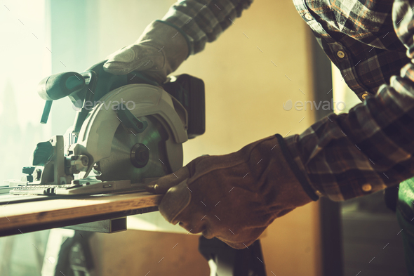 Carpentry Worker Cutting Piece of Wood Board to Size - Stock Photo - Images