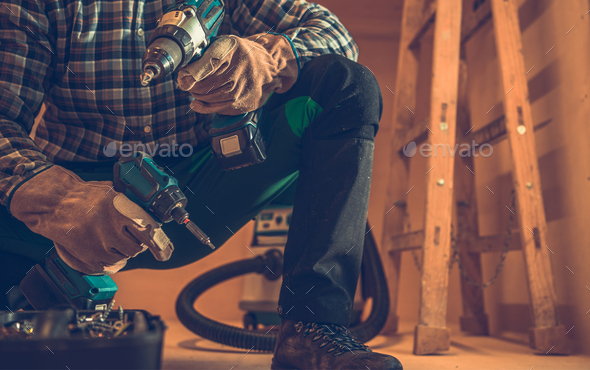 General Woodwork Contractor with Drill Drivers in Both Hands - Stock Photo - Images