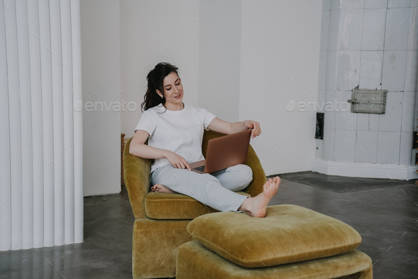 Tired young woman working has online courses, satisfied by knowledge, possibilities, sits in chair