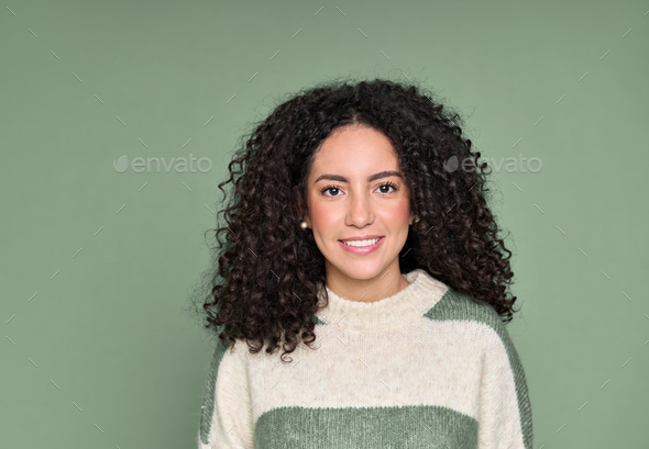 Young smiling latin woman standing isolated on green background, portrait. - Stock Photo - Images