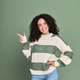 Young smiling happy latin woman pointing aside isolated on green background. - PhotoDune Item for Sale