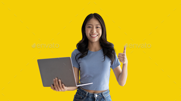 Asian woman in casual clothes holding working laptop in freelance work concept  - Stock Photo - Images