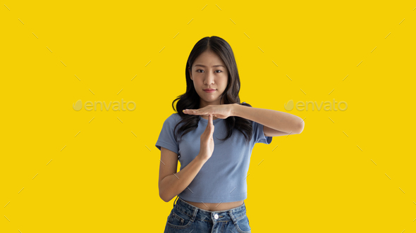 Woman makes a T hand sign indicating a request for a time-out or a temporary break - Stock Photo - Images