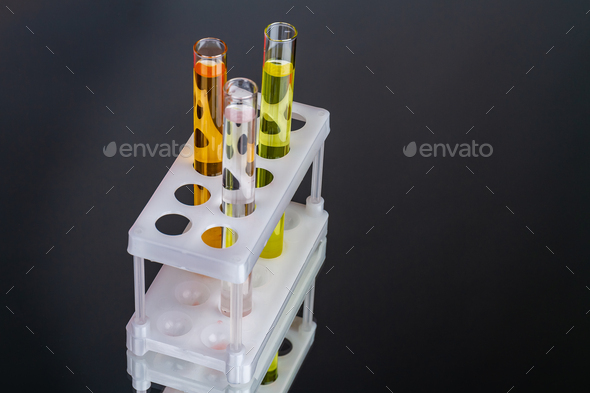 Close up solve and transparent lab test tubes.
