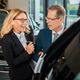 businessman and smiling businesswoman with smartphone choosing new car in dealership salon - PhotoDune Item for Sale
