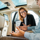 close-up shot of adult man and female car dealer sitting on back seat of luxury car and talking - PhotoDune Item for Sale