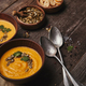 delicious pumpkin soup in bowls and spoons on wooden table - PhotoDune Item for Sale