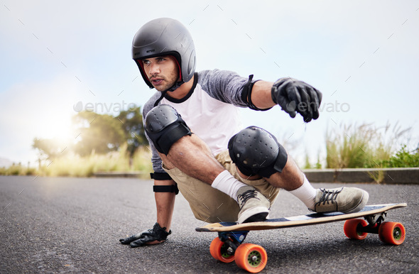 Skateboard slide, action and man in road for sports competition, training and balance in city. Skat