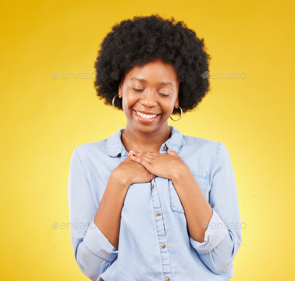 Black woman, happy and self love with hands on chest, peace and calm with eyes closed on yellow stu