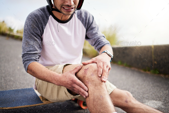 Injury, man and knee pain after skateboarding accident, practice and learning to skate. Active, bad