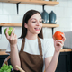 woman cooking healthy food from fresh vegetables and fruits in kitchen room. - PhotoDune Item for Sale