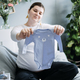 Pregnant woman with big belly holding bodysuit and sorting clothes for future. How to Organize - PhotoDune Item for Sale