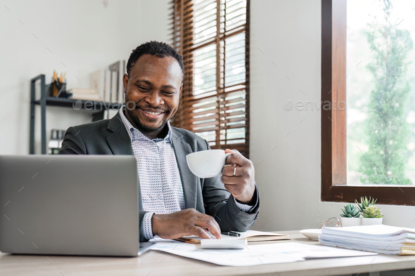 Success at work, good deal. African-American guy looks at the laptop screen, screams excitedly and - Stock Photo - Images