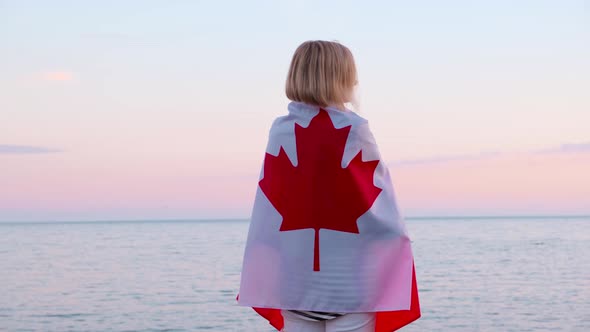 Back View Woman in Summer Clothes with National Canada Flag Outdoors Ocean Sea Sunset Canada Flag alt