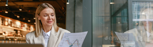 Businesswoman making online videoconference and demonstrate financial graphs to colleagues in cafe - Stock Photo - Images