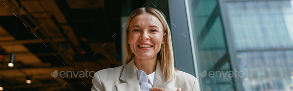 Smiling businesswoman communicating in sign language while looking at camera and sitting in cafe - Stock Photo - Images