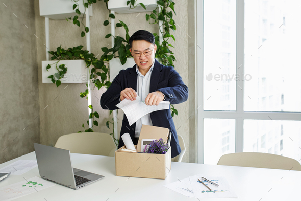 Firing and job loss concept. Asian male employee unhappy with excessive work. - Stock Photo - Images