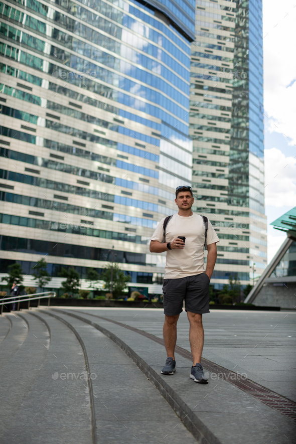 A man near high-rise buildings
