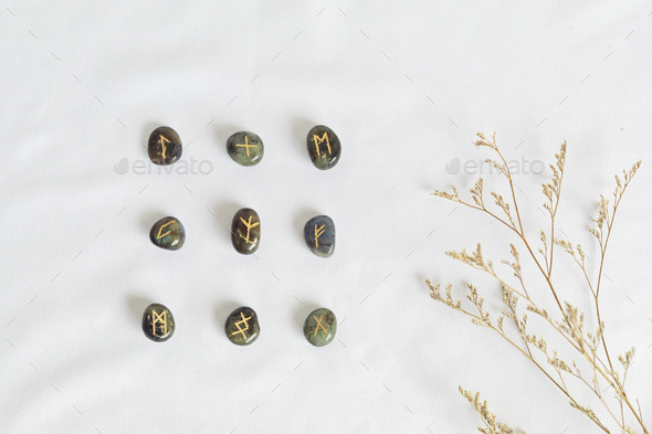 Set of rune stones for divination and fortune telling Stock Photo by OksaLy