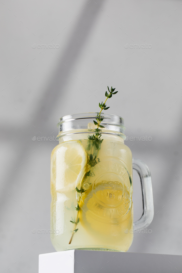 Promotional photo of lemonade with fresh lemon slices in a glass on the podium. Summer rdrink - Stock Photo - Images